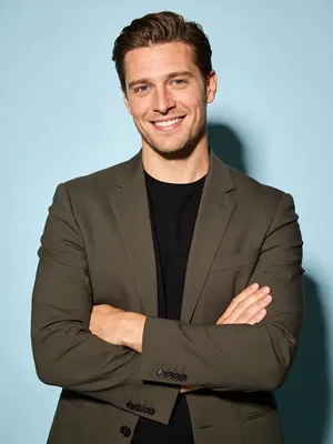 White man in studio half-body portrait with clean editorial lighting