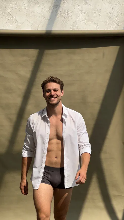 White man in studio wearing open button-down and boxer-briefs for editorial dudeoir photo