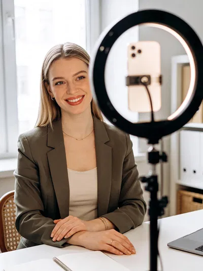 White woman creator headshot with ring light setup, ready for social posts