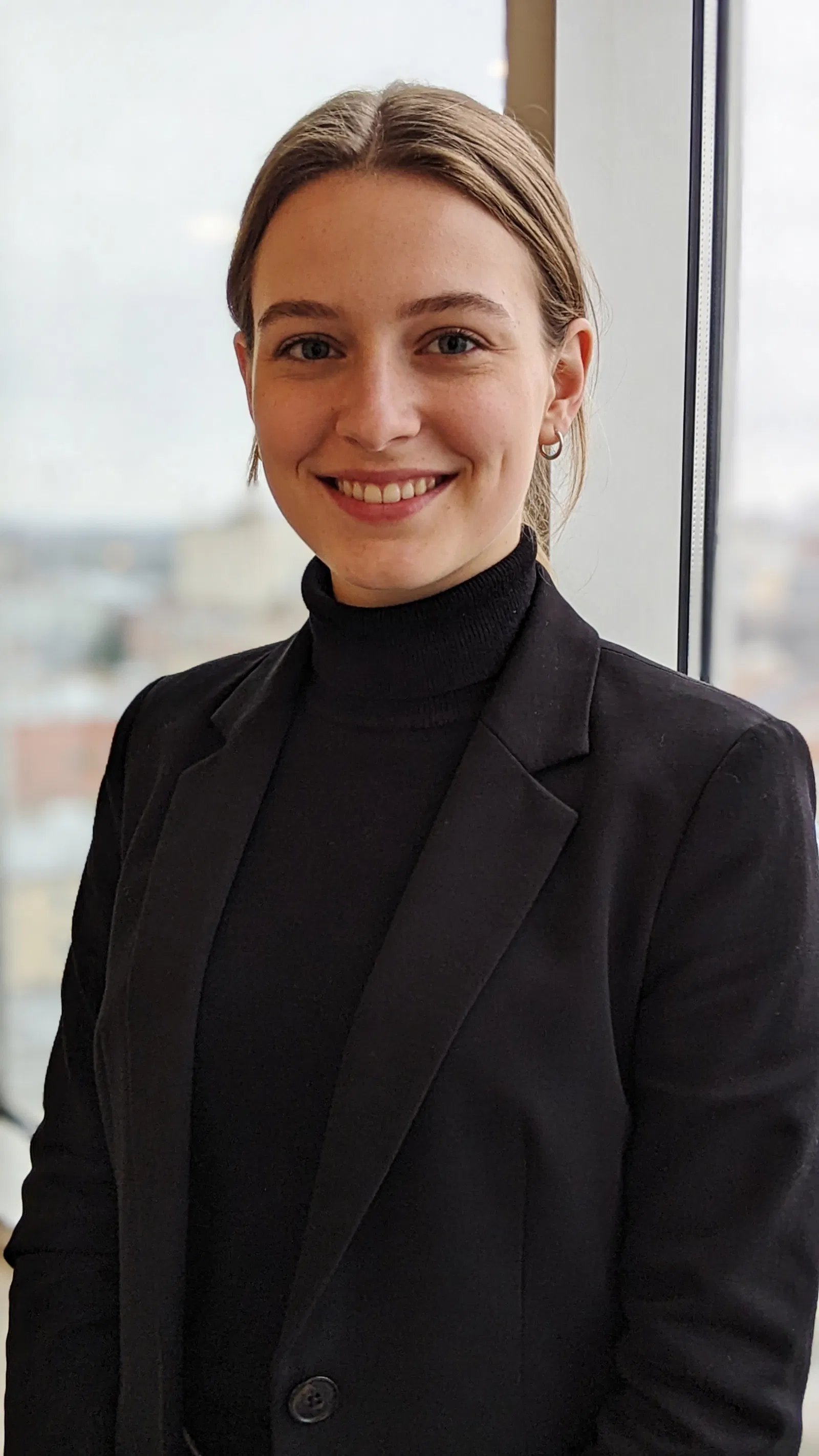 White woman near window with modern professional resume portrait