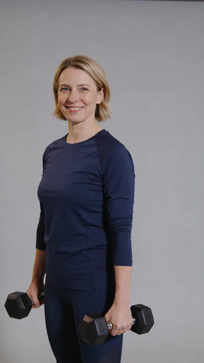 Woman studio dumbbell portrait for affordable fitness photoshoot